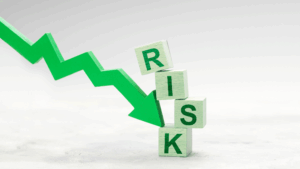A green arrow pointing sharply downward, next to blocks labeled "RISK," illustrating hidden risks reducing business valuation.